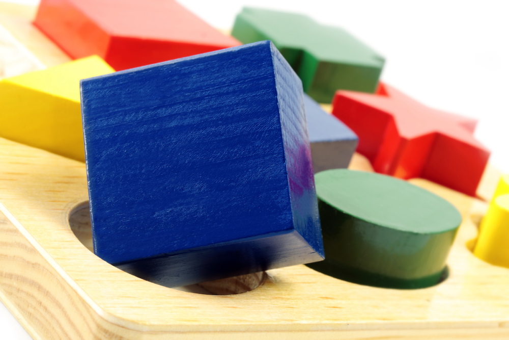 图片:在一组儿童彩色玩具块,蓝木多维数据集无法融入一个圆孔。